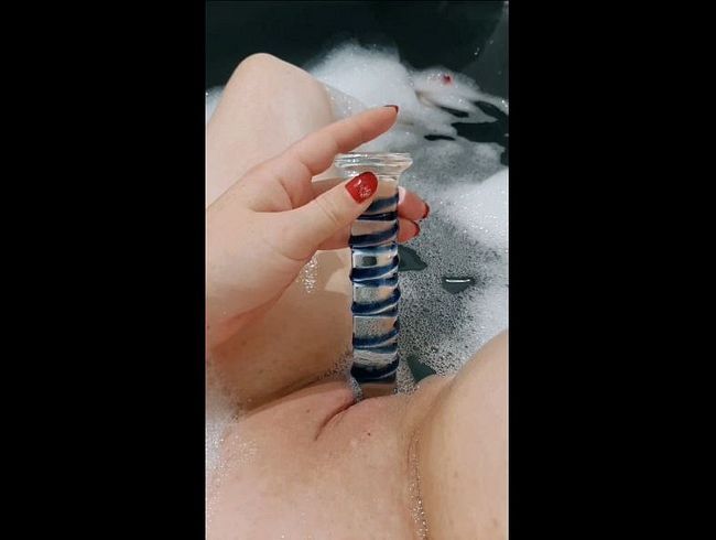 Hot in the tub...used both holes with the glass dildo. Yes, she can do that!